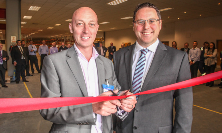 Charlie Stewart of Scottish Enterprise and Richard Sadler, managing director of Score Europe, cutting the ribbon on the new premises in Glenrothes in June.