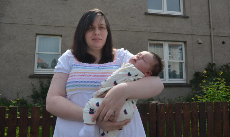 Ms Irvine and baby Louise outside their Markie Avenue home.