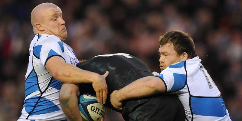 Scotland's Scott Lawson (left) and Allan Jacobsen (right) tackle New Zealand's Luke Romano