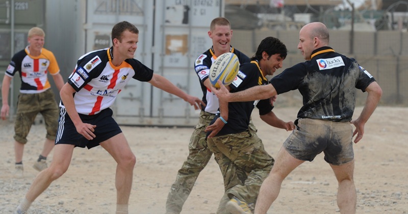 Captain (Capt) Stuart McCrimmon (pictured right) takes the ball in a rugby game played on a make shift pitch In Forward Operating Base (FOB) Shawqat in Southern Afghanistan. Stuart McCrimmon has spent the past week training up members of the Afghan National Army (ANA) to take pare in the game.    

The support for the game came from the Lawrence Dallaglio Trust  with the initial idea coming from Captian (Capt) Alex Pounds, the Training Officer at the Royal Marine Reserves (RMR) based in London.  Footage from the game is due to be aired at the match for heroes at Twickenham on St Georges Day (23 Apr 11).  Proceeds from the event will go to Help for Heroes, the Benevolent funds across the three services and the Royal Marines own charity, the C Group.    

The new arrivals from the Commando unit will spend the duration of their tour co located with the Afghan National Security Forces (ANSF) and they hope to organise more events that will support their close working relationship with the Afghan soldiers.   
 
NOTE TO DESKS: 
MoD release authorised handout images. 
All images remain crown copyright. 
Photo credit to read - Sergeant Alison Baskerville RLC