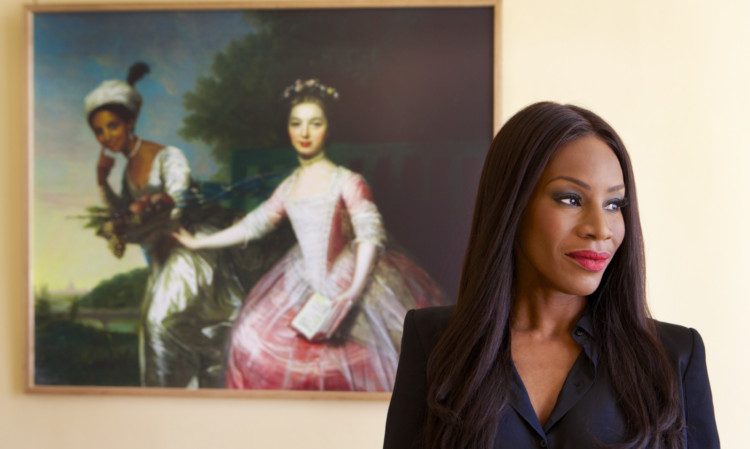 Amma Asante, the film Director of Belle movie, in front of the portrait of Dido Elizabeth Belle and her cousin Elizabeth.