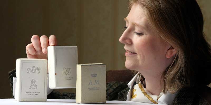 Steve MacDougall, Courier, Queens Hotel, Perth Road, Dundee. Lisa Campbell, ex-office manager for catering at Buckingham Palace,  found cake boxes from the royal weddings of Princess Anne (73), Prince Charles (81) and Prince Andrew (86). Lisa is holding Charles and Diana's cake box, which still contains cake. PICTURE TO BE HELD SUNDAY FOR MONDAY.