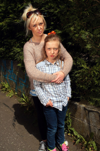 John Stevenson. Courier. 21/05/14. Dundee. Needle Jab story. Pic shows Louise kerr (98 Lauderdale Ave) with her 10 yr old daughter Tia Barty who was jabbed by abandoned needles while playing hide and seek with her pals . Pic shows them in the lane between Americanmuir Road and Turriff Place where the incident occured.