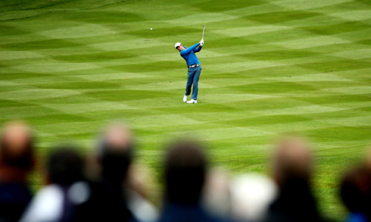 Rory McIlroy escapes from the madding crowds on the 4th fairway at Wentworth.