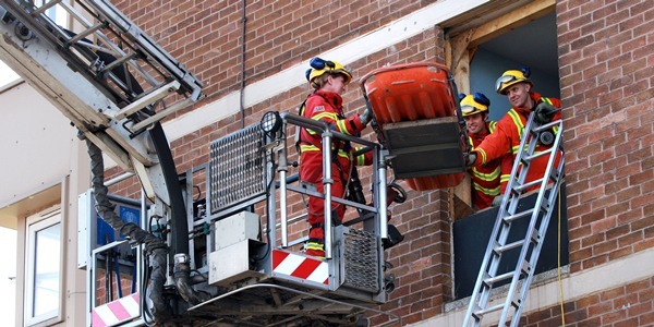 Kris Miller, Courier, 25/04/11. Picture today at Maxwelltown tower, Hilltown, Dundee. Safedem, who are in charge of the demolition of the multi's gave the firebrigade access to the buildings to allow them to practice emergency rescue's. Firefighters used visual and listening devices to locate 'casualties' and remove them safely from the building. Pic shows firefighters removing a casualty from the building using the aerial platform.