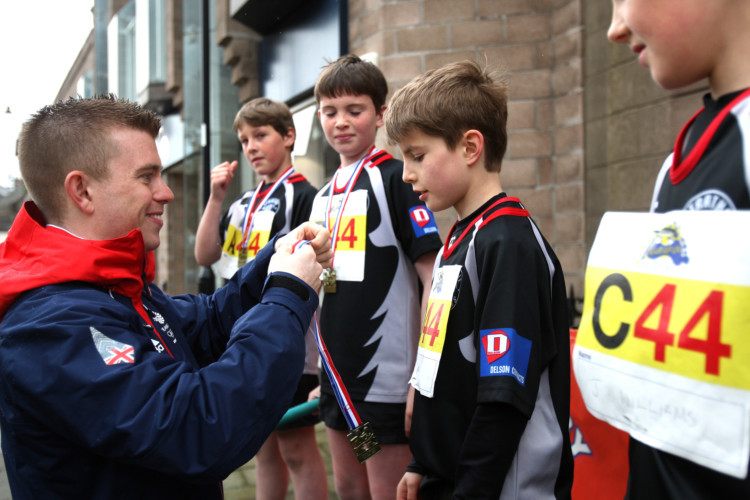 Forfars Olympic hero Greg Drummond (left) was back in his hometown to support the Angus Marafun on May 25. The towns High Street was closed to create a 0.65-mile circuit for the relay race organised by Forfar Rotary. This year 34 teams took part in the full marathon, with each of the five team members completing eight laps of the course.