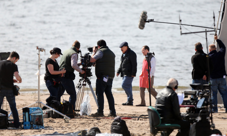Brian Cox and Jonathan Watson filming scenes on the beach.