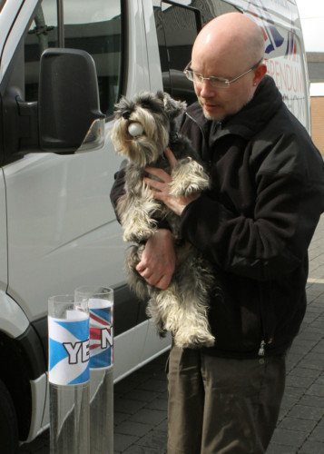 COURIER, DOUGIE NICOLSON, 26/05/14, NEWS.
Pictured at The Courier Referendum Roadshow in Lochgelly today, Monday 26th May 2014, Dolan the Miniature Schnauzer helsp owner James Bruce to cast his vote......Hope he had a good aim!! Story by Fife.