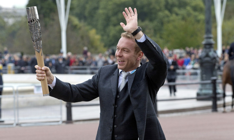 Sir Chris Hoy carries the Commonwealth games at the ceremony to start the relay at Buckingham Palace.