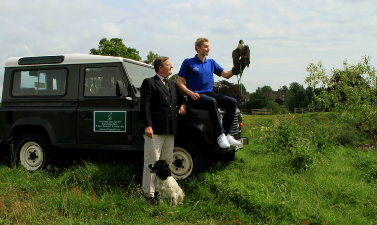 Stephen Milne holding a peregrine falcon at Scone Palace yesterday, with David Noble and Bertie the spaniel.