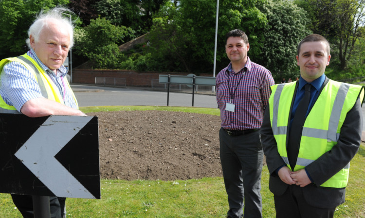 From left: councillor Jim Young, Richard Brown and Councillor David Graham at a roundabout in Leven where plants have been stolen.