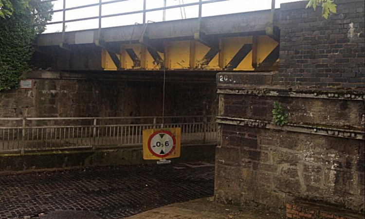 The sign was left dangling off the railway bridge.