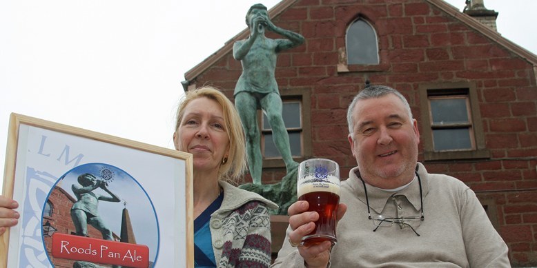 Kim Cessford, Courier - 27.04.10 - the Roods Bar in Kirriemuir lends its support to the Barrie 2010 celebrations with the introduction of a Peter Pan Pale Ale - pictured in Kirriemuir Square are Sylvia and  Jim Glendinning - words from Graham in Forfar