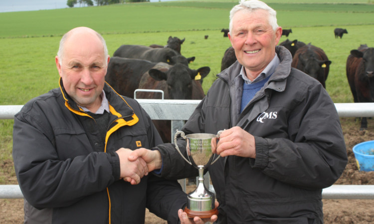 Ian Whiteford, right, presenting the silage trophy to Drew Wilson.