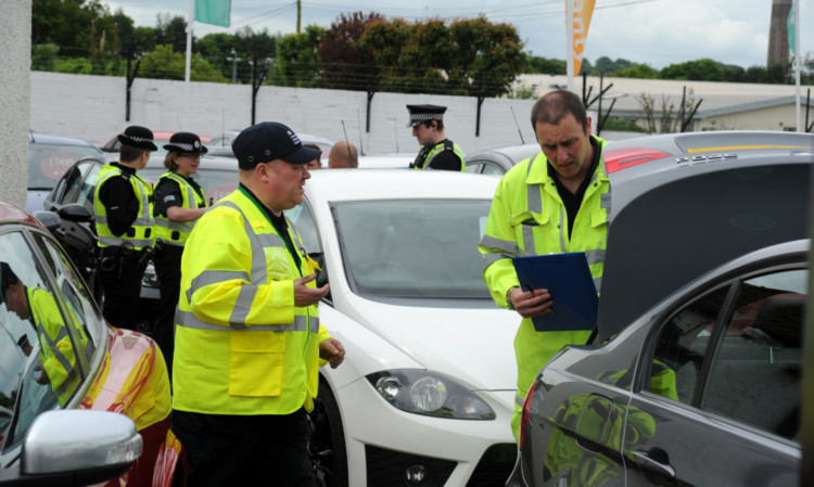 Police and other agencies swoop on Glencross Motors in Clepington Road.