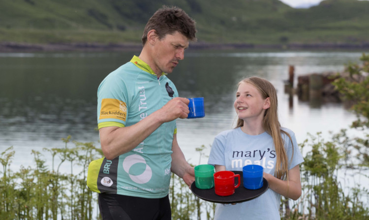 Martha Payne serves Rob Wainwright a mug of likuni phala.