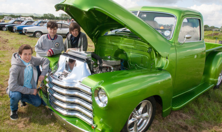 Classic car fans Marcus Ryan, Kaleb Thomson and Brodie Borland admire a 1949 Chevrolet pick-up.