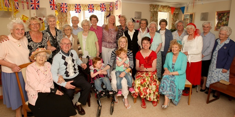 Kim Cessford, Courier, - 29.04.11 - the Carnoustie twins dropped in on the residents of Hometay House, Monifieth where the royal weddingt was being enjoyed on a big screen lent by Hosies - a collection had been made towards the cahrity fund for the twins - pictured centre l to r - Chloe, Ayley and mum Averil - with residents - words from Craig