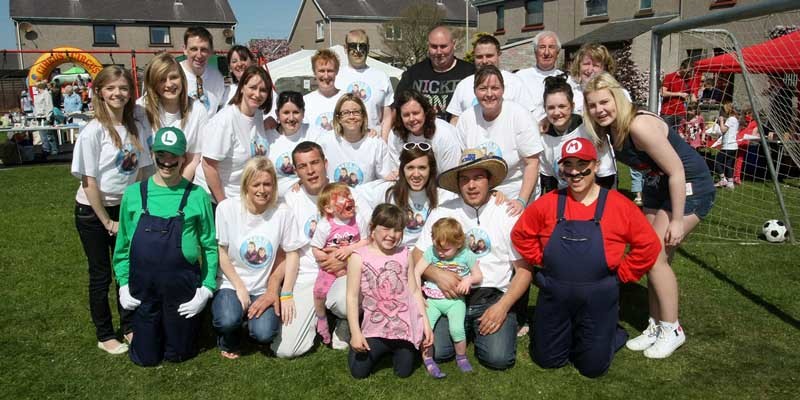 Kim Cessford, Courier 30.04.11 - a fun day was organised to help with the fund raising for Carnoustie twins Chloe and Ayley - pictured on the green at Winter Place, Carnoustie are the volunteer helpers who helped the day go with a swing