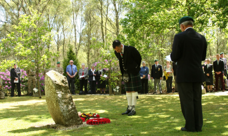 Colin Leeming, son of Sergeant Bob Leeming, bows at the Falklands Stone after laying a wreath in his fathers memory.