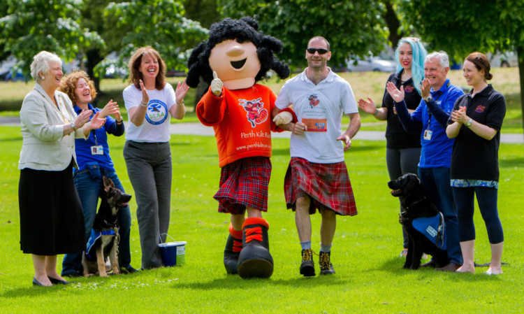 Mascot Harry McKilty at the Kilt Run official launch with (from left) Provost Liz Grant; Margaret Donald, Guide Dogs Scotland volunteer, with guide dog pup Jan; Fiona Dennis, community fundraiser with Scotlands Charity Air Ambulance; organiser Nicholas Kydd; Iona Baird, from Home Start Perth; Bob Donald, Guide Dogs Scotland volunteer, with guide dog pup Wendy; and Kirsty Richardson, Home Start Perth.