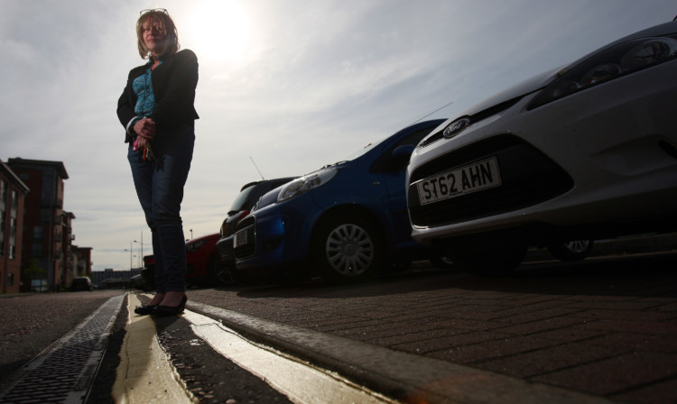 Lynne Noble beside the yellow lines that had residents seeing red.