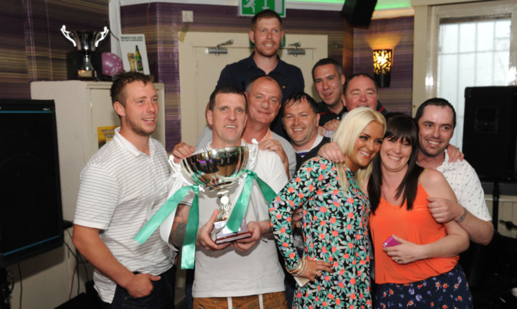 Kelty Celtic and fans with the cup they won.