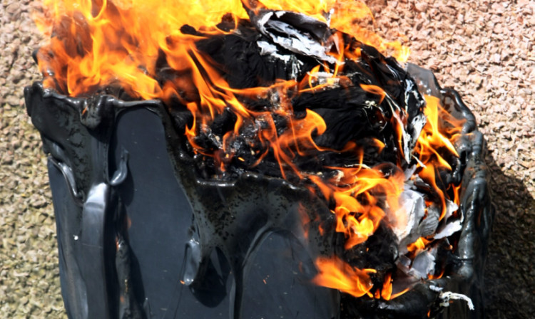 A wheelie bin on fire at the demonstration in Whitfield.