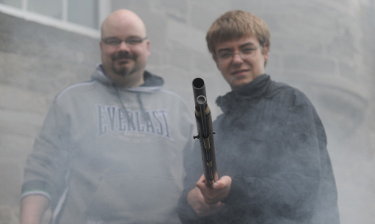 Archivist Richard McKenzie and visitor Iain MacLean, 15, with an 18th century musket.