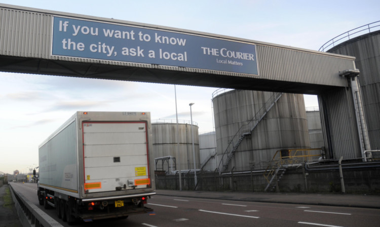 An early-morning lorry passes the new Courier ad.
