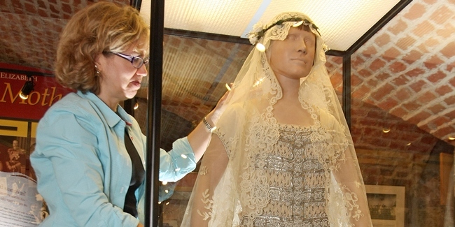Kim Cessford, Courier - 05.05.11 - pictured at Glamis Castle is Deborah Phipps (Textile Conservator) putting the final touches to the Queen Mum's wedding dress display