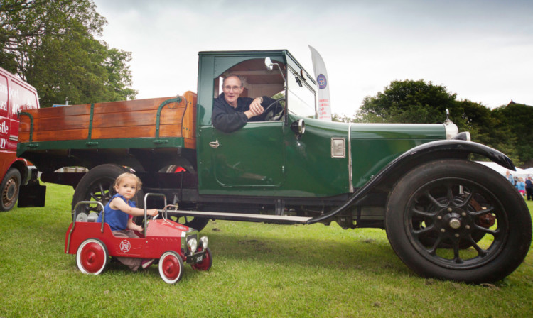 Three-year-old Lizabet Eggleton-Hunter from Forfar in her little fire engine with Bruce Rae in his grown-up truck, a 1925 Austin Clifton.
