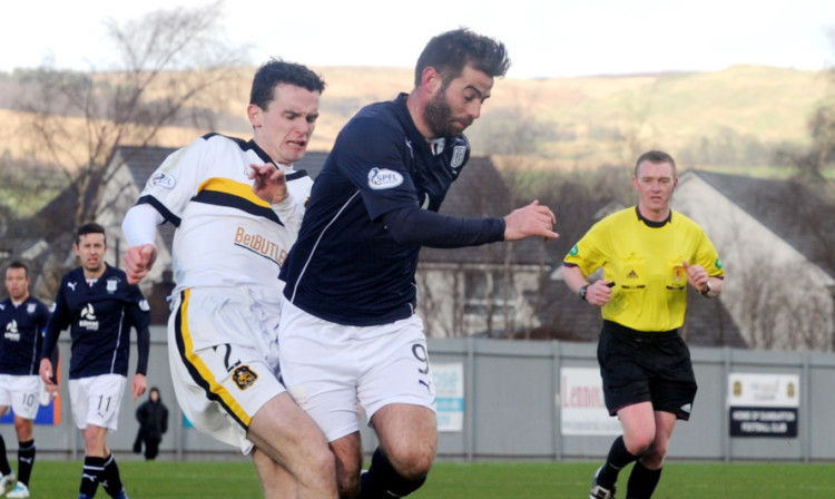 Paul McGinn up against Dundee striker Peter MacDonald last season.