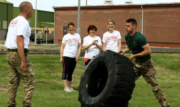 At RM Condor, Emily Sandwell (left) and Erica Silcocks (right) from the Sandpiper Trust, with Michelle McDermott from Help Our Wounded, watching some of the marines training.