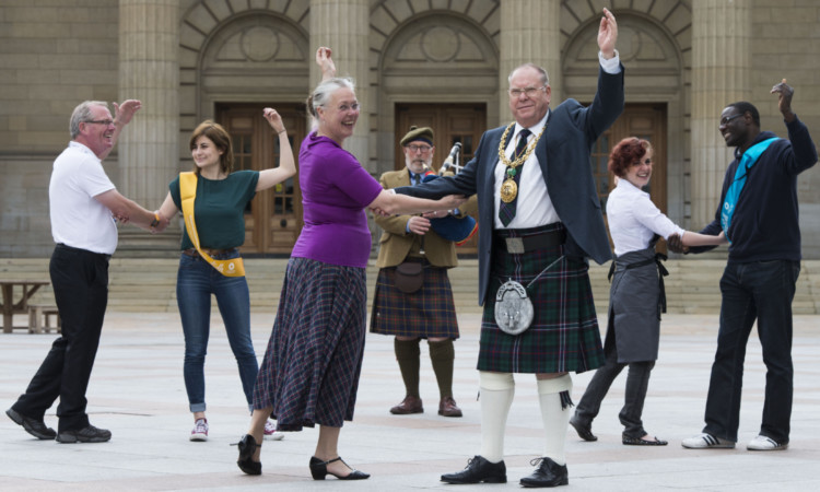 Royal Scottish Country Dance Society caller and teacher Pia Walker dances with Lord Provost Bob Duncan.