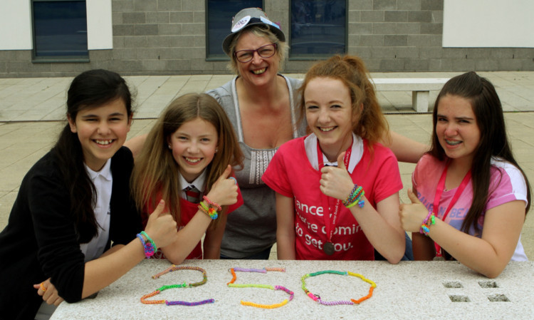 Shona Duncan of Broughty Ferry Cancer Research shop with, from left, Sophie Prendiville, Katie McGill, Laura McGill and Holly Ross.