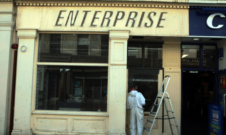 Work progressing on the exterior of the former RS McColl shop on Reform Street.