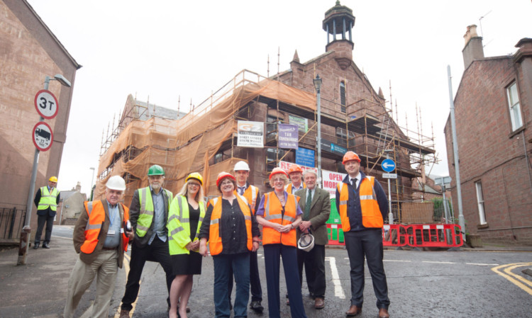 Redford Homes managing director Lorna Redford (fourth from the left) next to Margaret Burgess (fourth from the right) ahead of the tour of the building.