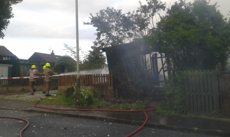 Firefighters tackle the blaze at Dalmahoy Drive.