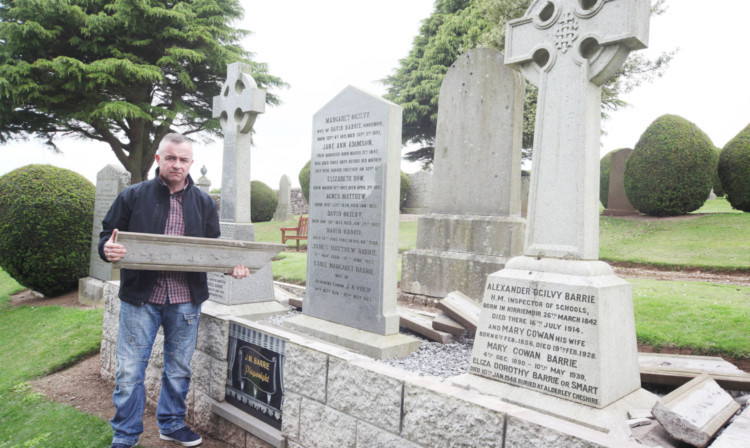 Kirriemuir Community Council chairman David Milne next to the damaged grave.