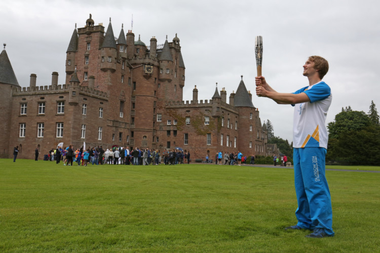 Thousands lined the streets and roads of Angus to welcome the Queens Baton Relay at the weekend. The baton received a warm welcome from Monifieth to Montrose as it makes its way to the Commonwealth Games in Glasgow.Stewart Watson carries the Glasgow 2014 Queen's Baton at Glamis Castle.