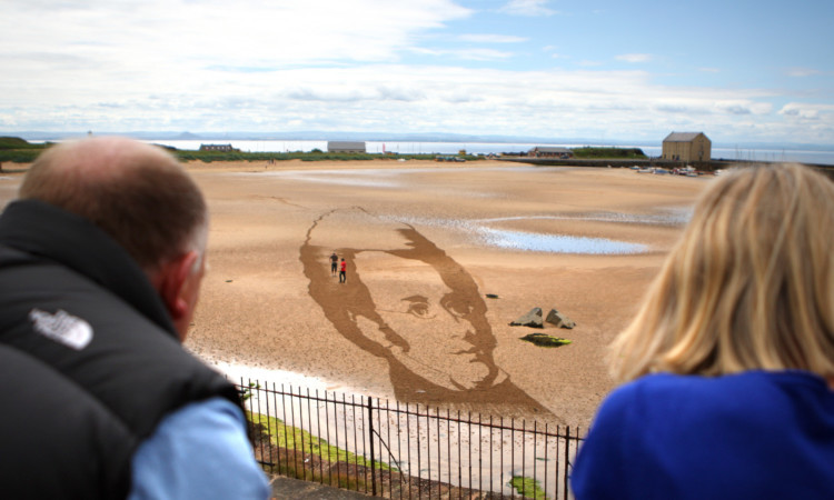 Locals watching the portrait take shape.