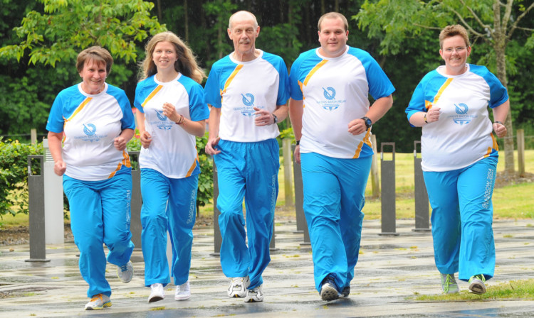 Some of the baton bearers limber up in anticpation of the Queens Baton Relay arriving in Stirling. From left: Fiona Bennie, 51, Dunblane Sports Club; Rhona Callander, 15 and Jim Prentice, 68, both Stirling Bike Club; Cameron Bennie, 20, Dunblane Sports Club and Carol Anderson, 42, Stirling Wanderers Hockey Club.