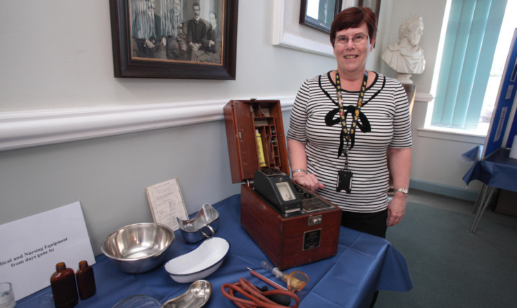 Liz McNiven, catering and conference administrator at PRI, is pictured with some of the exhibits.
