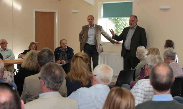 Councillors Tom Gray, left, and Murray Lyle discuss the T in the Park move at a meeting in Aberuthven Village Hall.