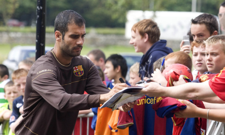 Then Barca boss Pep Guardiola signs autographs at St Andrews in 2008.