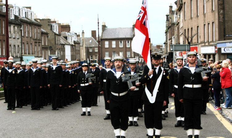 Members of the ships company line up in the High Street in Montrose.