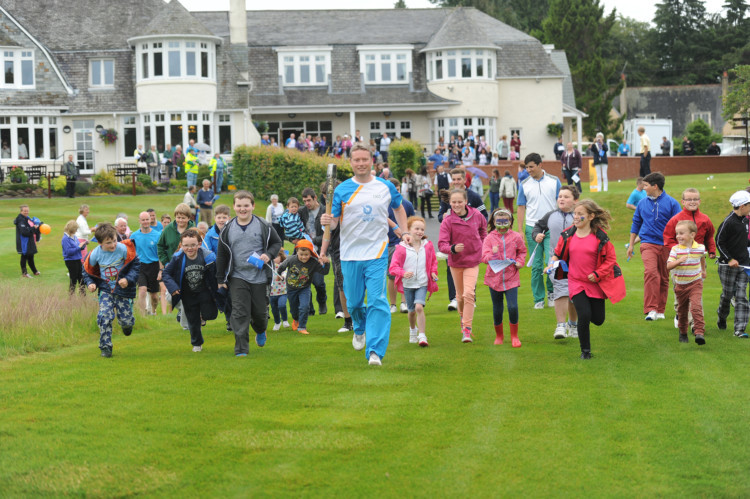 The Queens baton enjoyed a triumphant arrival in Perth and Kinross as thousands cheered on its bearers on July 4. Highlights included a visit to the former crowning place of Scottish kings at Scone Palace and a flotilla of canoes down the Tay to Perth, with fireworks to greet them. It ended the day at a huge event on the North Inch. This photo shows former Amateur golf champion Stuart Wilson with some of the junior club members and youngsters who wanted to see the baton when it arrived at Blairgowrie Golf Club.