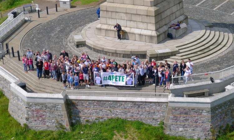 Peter McAvoys family and friends gather on top of the Law to be photographed by a drone and hold a raffle in aid of the British Heart Foundation.
