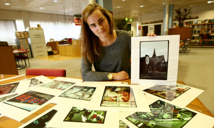 Amy Clark with some of the old photos.